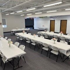 Empty banquet hall with tables and chairs.